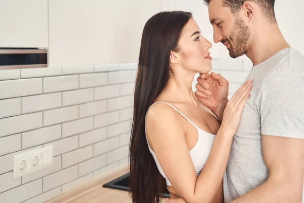 Romantic newlyweds embracing tenderly at kitchen area — Stock Photo, Image