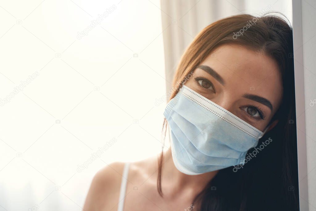 Portrait of an attractive brunette in medical mask