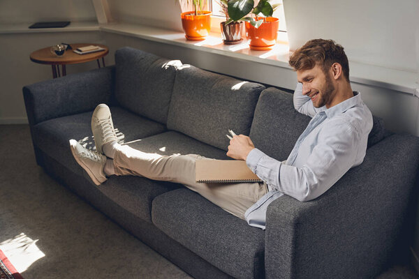 Pleased Caucasian manager staring at his notes