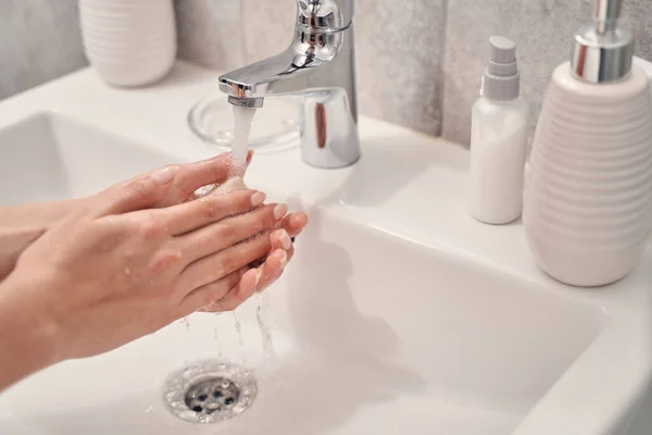 Kadın tuvalette ellerini yıkıyor. — Stok fotoğraf