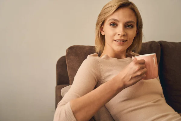 Mujer con una taza de té relajante en casa — Foto de Stock