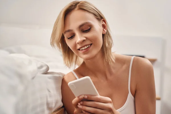 Mujer leyendo un mensaje de texto en su smartphone — Foto de Stock