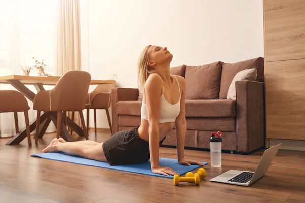 Relaxed calm sporty lady stretching her spine — Stock Photo, Image
