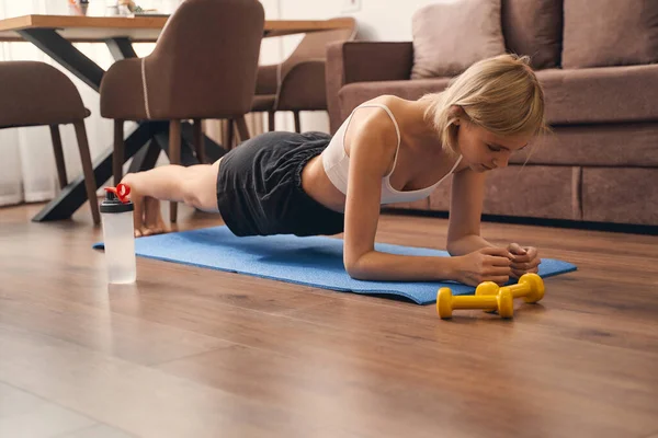 Formda bir kadın ön kol tahtası egzersizi yapıyor. — Stok fotoğraf