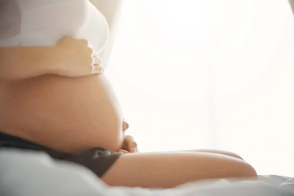 Bella pancia di donna incinta con le mani su di esso — Foto Stock