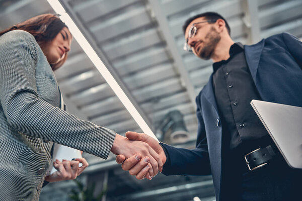 Two business colleague shaking hand during meeting