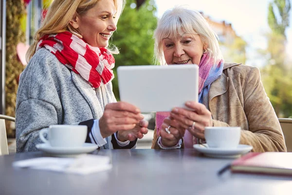 Щасливі дві жінки проводять час з сучасним планшетом — стокове фото