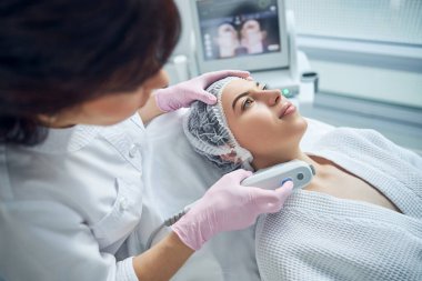 Rahatlamış çekici kadın cilt bakımı alıyor.