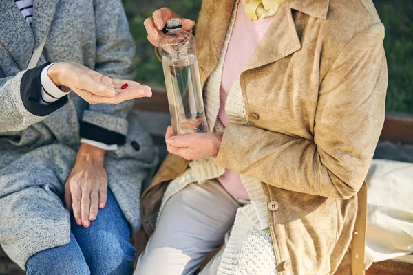 Cropped photo of lady giving pill for friend — Stock Photo, Image