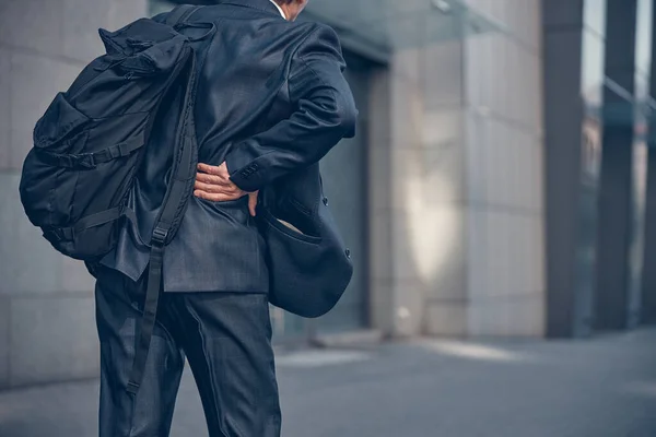 Homem com mochila sentindo dor na parte inferior das costas ao ar livre — Fotografia de Stock