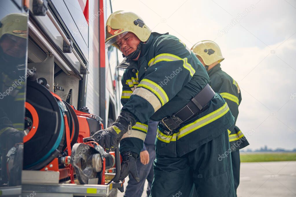 Firefighter installing equipment on the fire machine