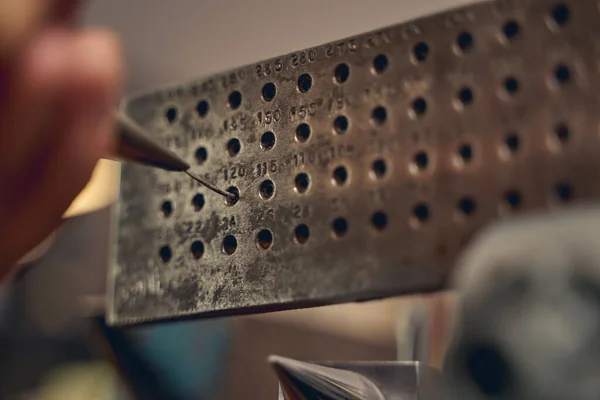 Experienced jeweler reducing thickness of metal wire — Stock Photo, Image