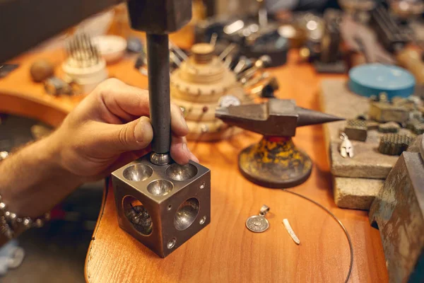 Experienced craftsman treating a piece of metal — Stock Photo, Image