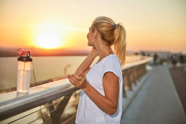 Blond vrouw praten op haar smartphone buiten — Stockfoto