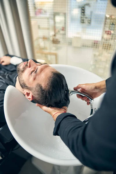 Fotografía enfocada en el hombre relajado que está en el salón — Foto de Stock