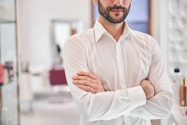 Handsome male person standing on the foreground — Stock Photo, Image