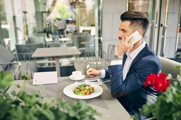 Busy brunette man being in cafe alone — Stock Photo, Image