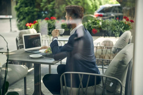 Busy young male watching video during pause — Stock Photo, Image
