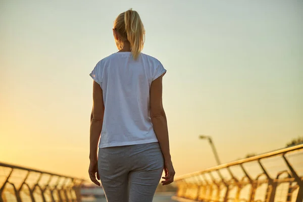 Blonde Frau im weißen Hemd steht auf der Brücke — Stockfoto