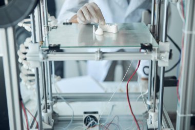 Diş modelini inceleyen deneyimli bir bilim adamı.