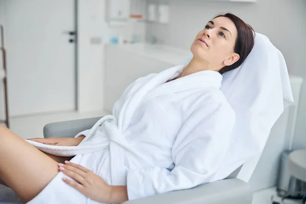 Attractive pensive adult spa client staring upward — Stock Photo, Image