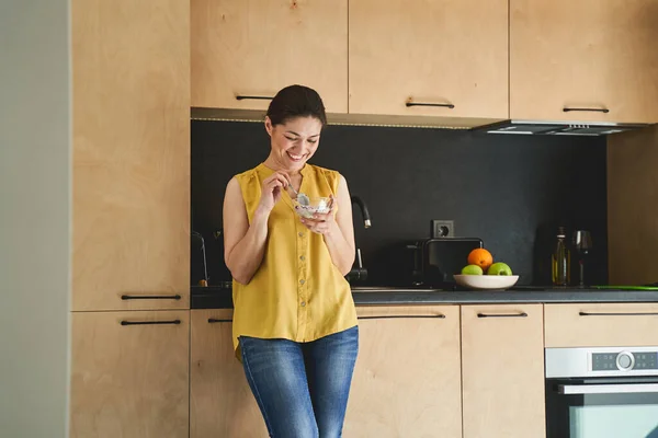 Señora sonriente desayunando en la cocina — Foto de Stock