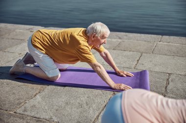 Rıhtımda çalışan beyaz saçlı Yogi.