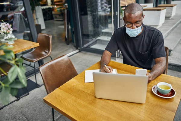 Delighted freelancer staring at screen of his gadget