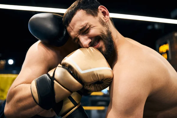 Professional athlete hurting after receiving a strike in the teeth — Stock Photo, Image