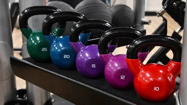 colorful metal kettlebells exercise equipment at gym