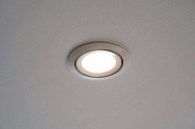 LED downlight or ceiling light Installed on a gray ceiling close up. clipart