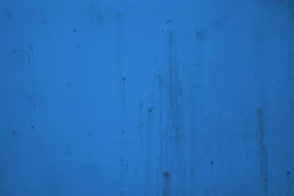 Black mold on a blue wall.