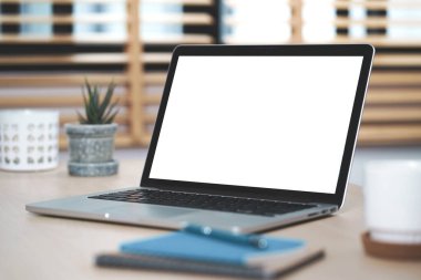 Kavramsal çalışma alanı, masadaki boş beyaz ekranlı dizüstü bilgisayar.