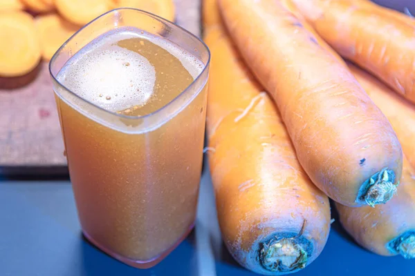 Detox juice. Carrot slimming juice (Daucus carota subsp. Sativus). Fresh and sliced carrots. Slimming drink. Natural drink with low calories.