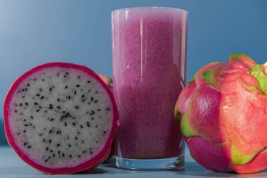 Pitaya suyuyla dolu cam bardak. Ejderha meyvesi olarak da bilinen egzotik bir meyve. Tarafsız bir tadı var, besin değeri yüksek. Ferahlatıcı, doğal ve detoks içeceği. Pembe Meyve suyu.