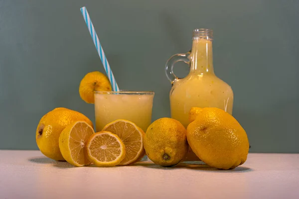 Refreshing lemonade drink. Lemonade is a refreshing drink that can accompany meals or compose a tasty snack. Lemon juice. Green background.