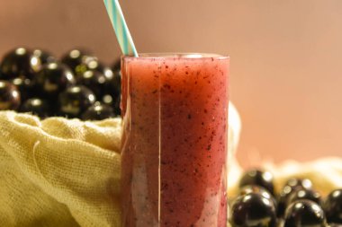 Taze meyve ve bir bardak jaboticaba suyu. Jabuticaba aslen Brezilyalı bir meyvedir. Atlantik Ormanı 'na özgü olarak, çiçekleri değil de gövdesinde filizlenen alışılmadık bir özelliğe sahiptir..