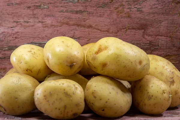 White English potatoes (Solanum tuberosum). English potatoes are the most common and consumed type. The tuber is very good at preventing constipation and helps the nervous system.