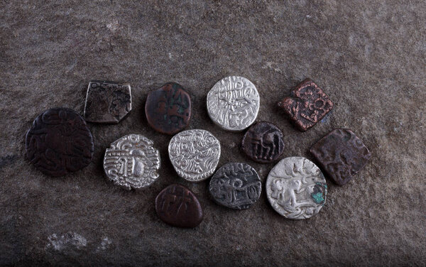 Ancient Indian coins on stone