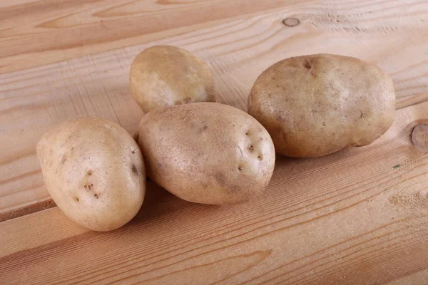 Potatoes on wooden table. Country style