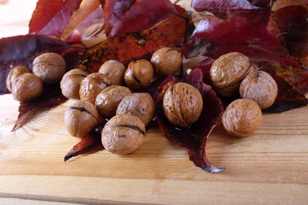 Walnüsse Und Herbstblätter Auf Dem Tisch — Stockfoto