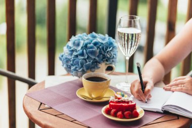 Balkonda sabah kahvaltısı, kruvasan, kahve ve böğürtlen.