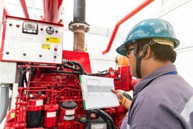 Engineer checking industrial generator fire control system, Diesel engine fire pump controller clipart