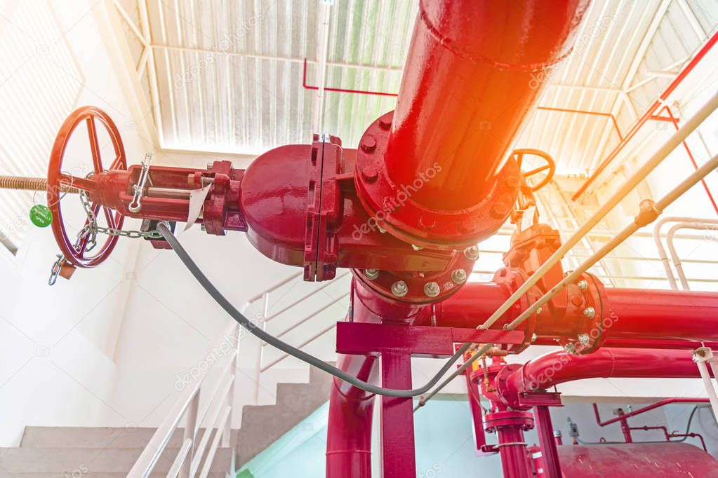 Close up of red pipe of fire pump system, red piping and valve control