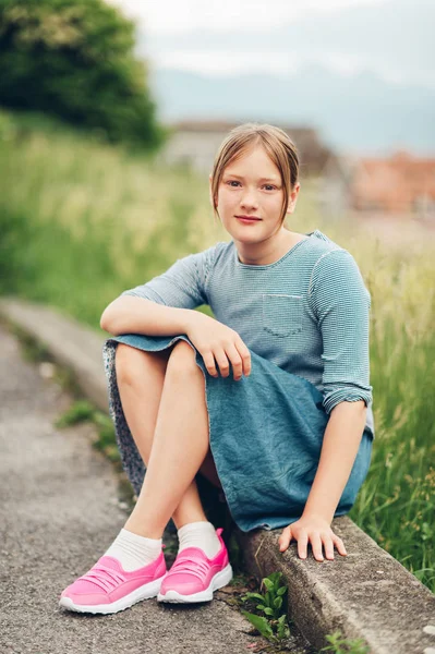 かわいいプレティーン 年古い女の子の屋外のポートレート ストライプ シャツ デニムのスカートとピンクのスニーカー — ストック写真