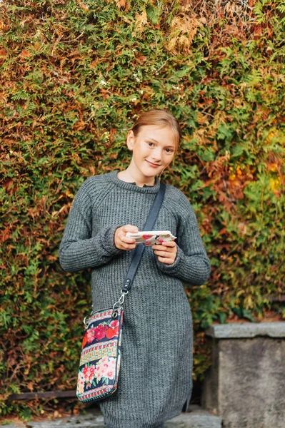 Young Schoolgirl Using Mobile Phone Outdoor Portrait Wearing Long Grey — Stock Photo, Image