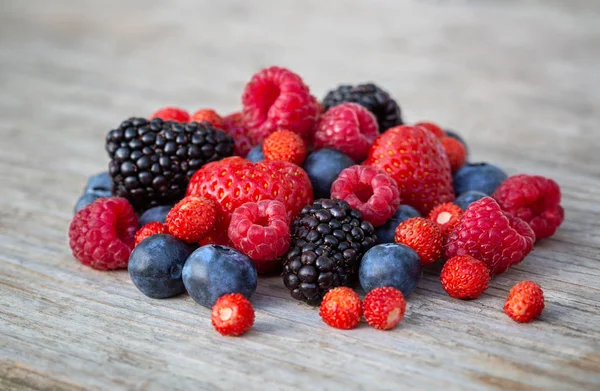 Ripe berries on a wooden board — Stock Photo, Image