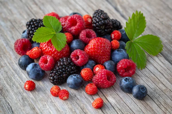 Ripe berries on a wooden board — Stock Photo, Image