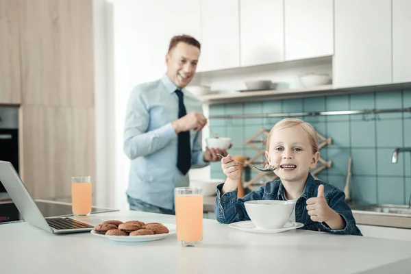 Charming little girl eating porridge — Stock Photo, Image