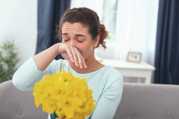 Young lady feeling hypersensitive to scent of blooming flowers — Stock Photo, Image